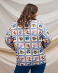 A multi colored quilted jacket with a floral print on one side and a blue solid color on the other. 