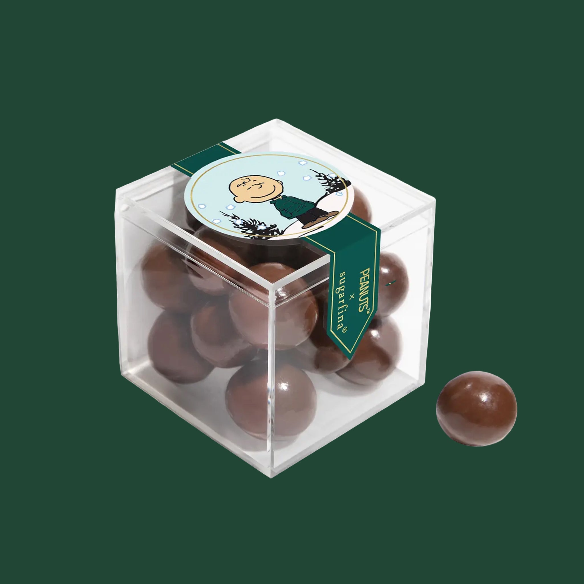 An acrylic box of chocolate covered candies. 