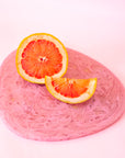 A pink resin decorative cheese or display board. 