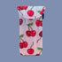 A blue and pink ombre puffy eyeglass case with a cherry print. 