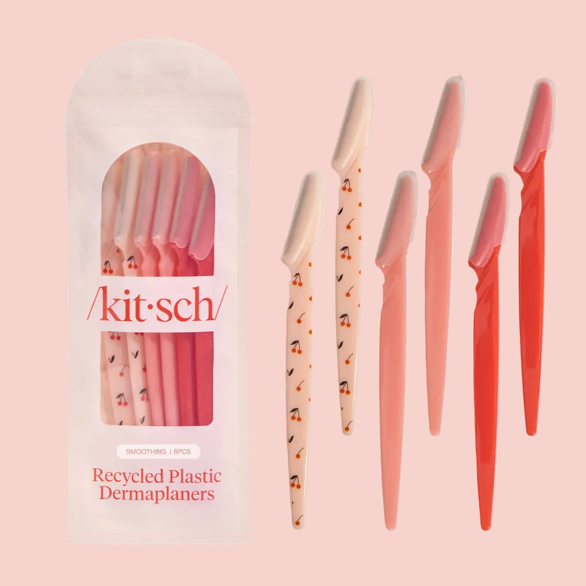 A pack of 6 face razors with cherry designs and pink and red ones.  "kitsch recycled plastic dermaplaners". 