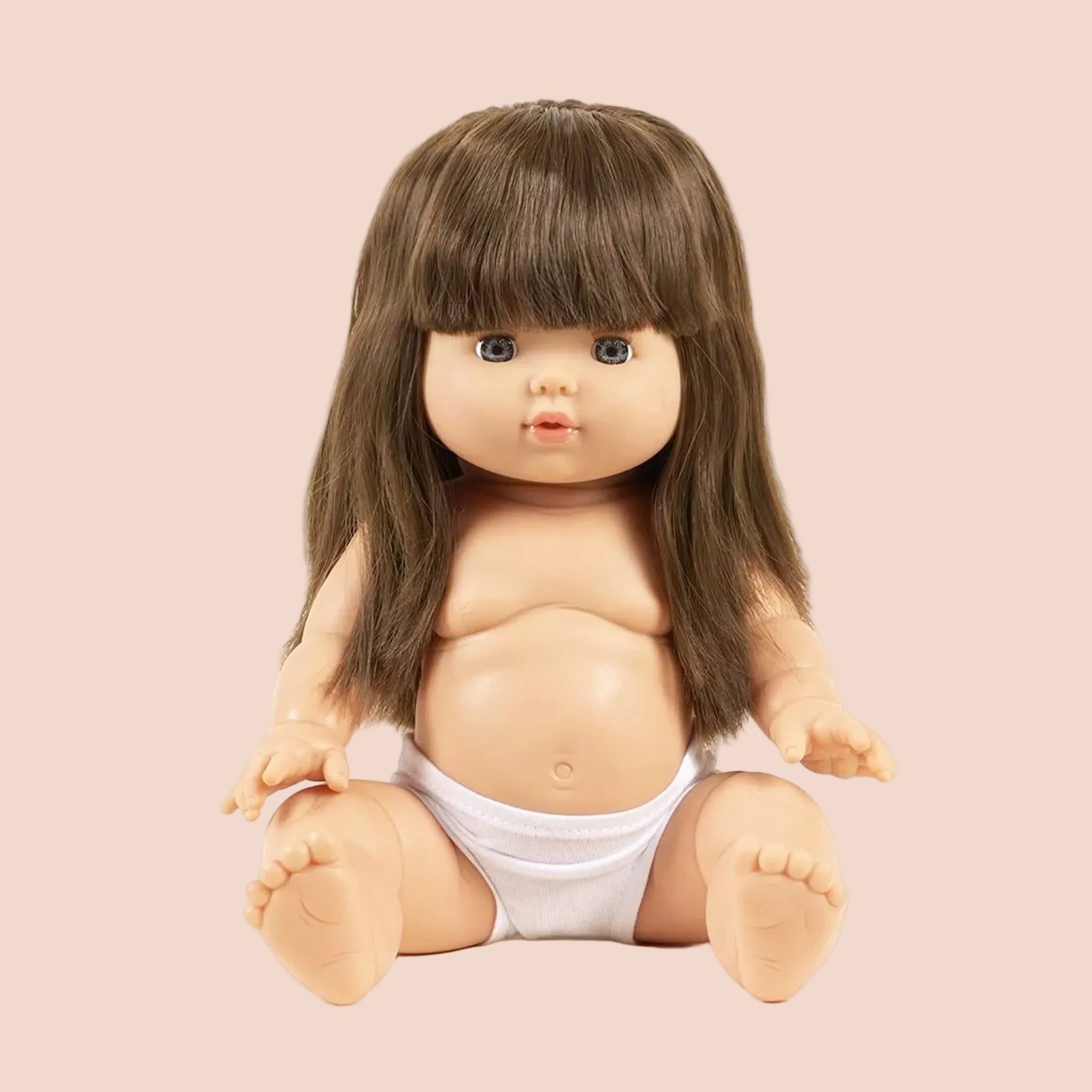 A baby girl doll with long brown hair. 