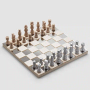 On a white background is a mirrored chess board game with wood pieces. 