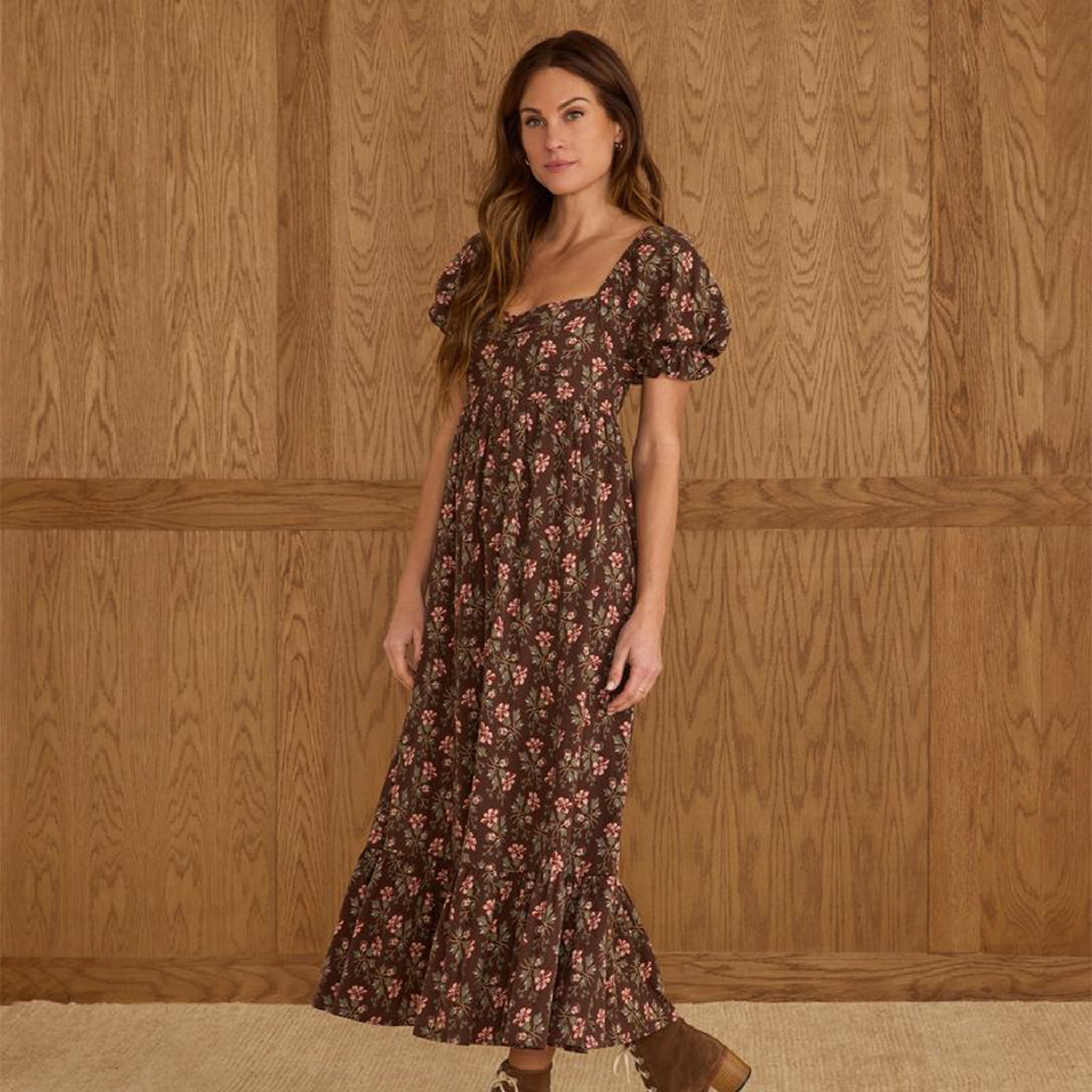 A brown puff sleeve dress with a pink and ivory floral print. 