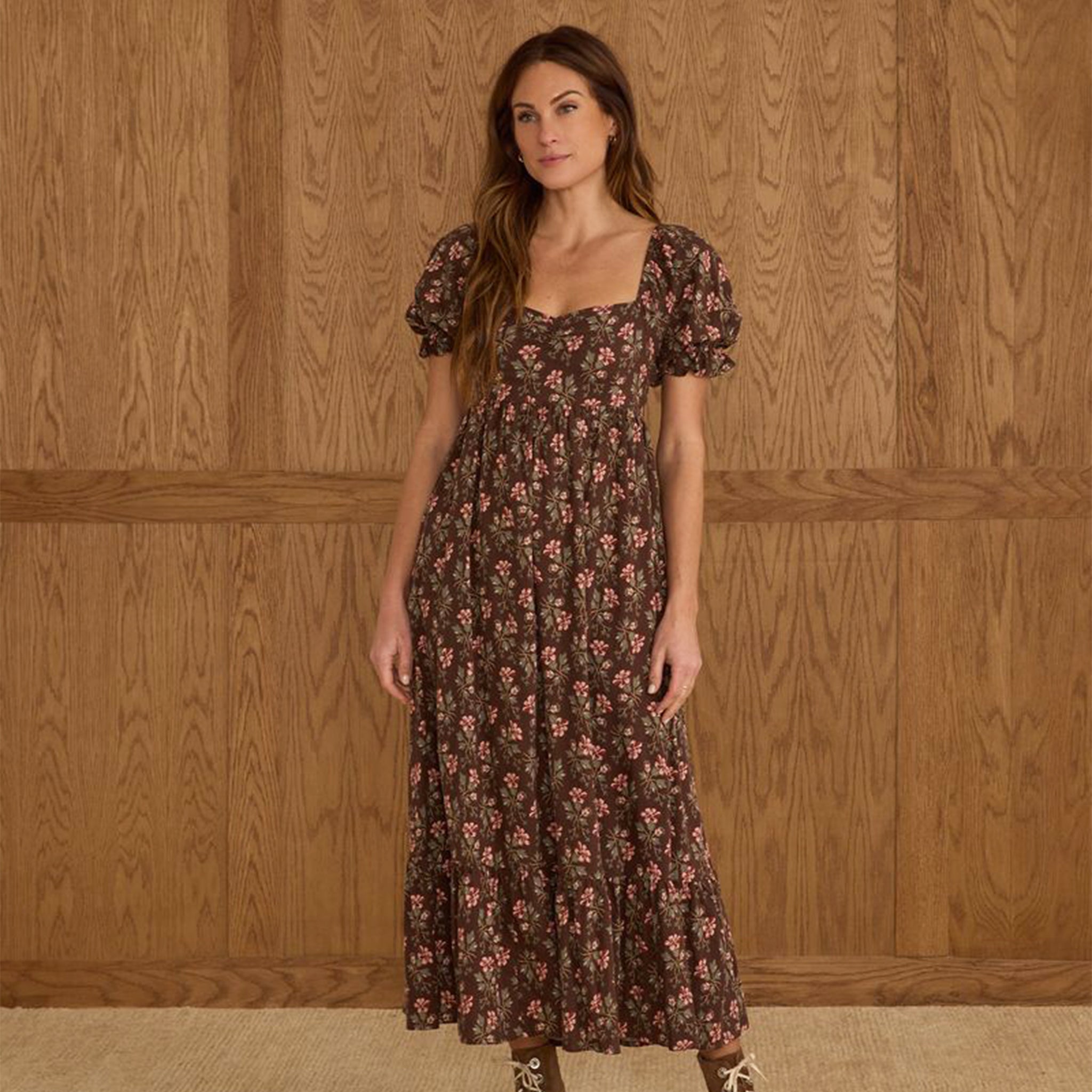 A brown puff sleeve dress with a pink and ivory floral print. 