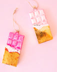 A pink and gold glass shaped chocolate bar with the loop for hanging. 