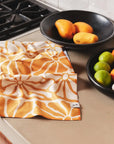 A yellow floral print kitchen towel. 