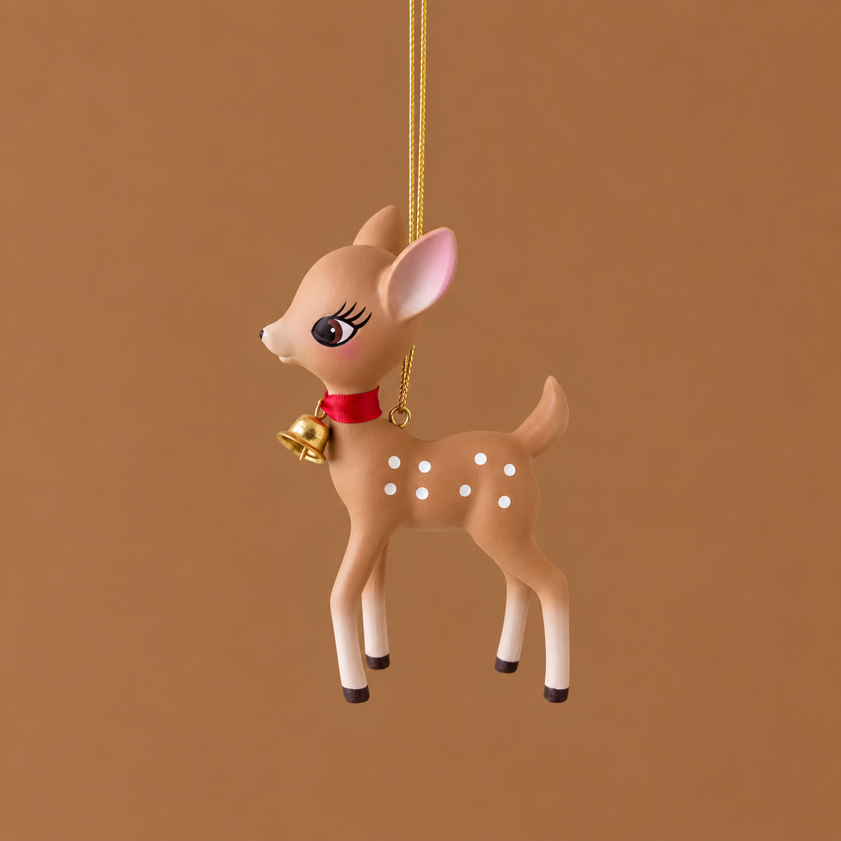 A tan retro deer ornament on a soft brown background.