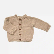 On a white background is a tan knit button up childrens cardigan with brown buttons. 