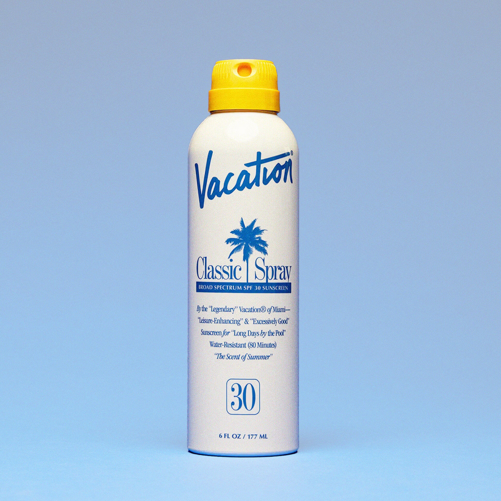 White glossy bottle of spray sunscreen. The bottle reads 'Vacation, Classic Spray, Broad Spectrum SPF 30 Sunscreen' in blue lettering. The bottle is complete with a yellow spray cap. 