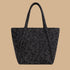 A black and grey tote bag with a floral pattern.