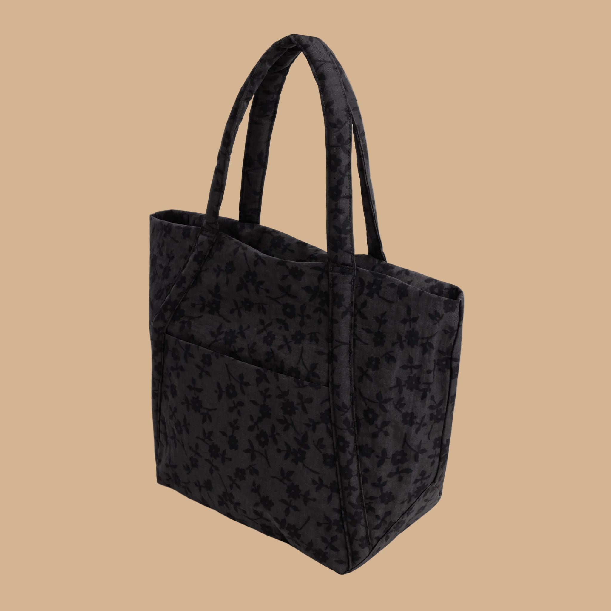 A black and grey tote bag with a floral pattern.