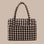 A blurred edge brown, black and tan gingham print nylon carry on tote. 