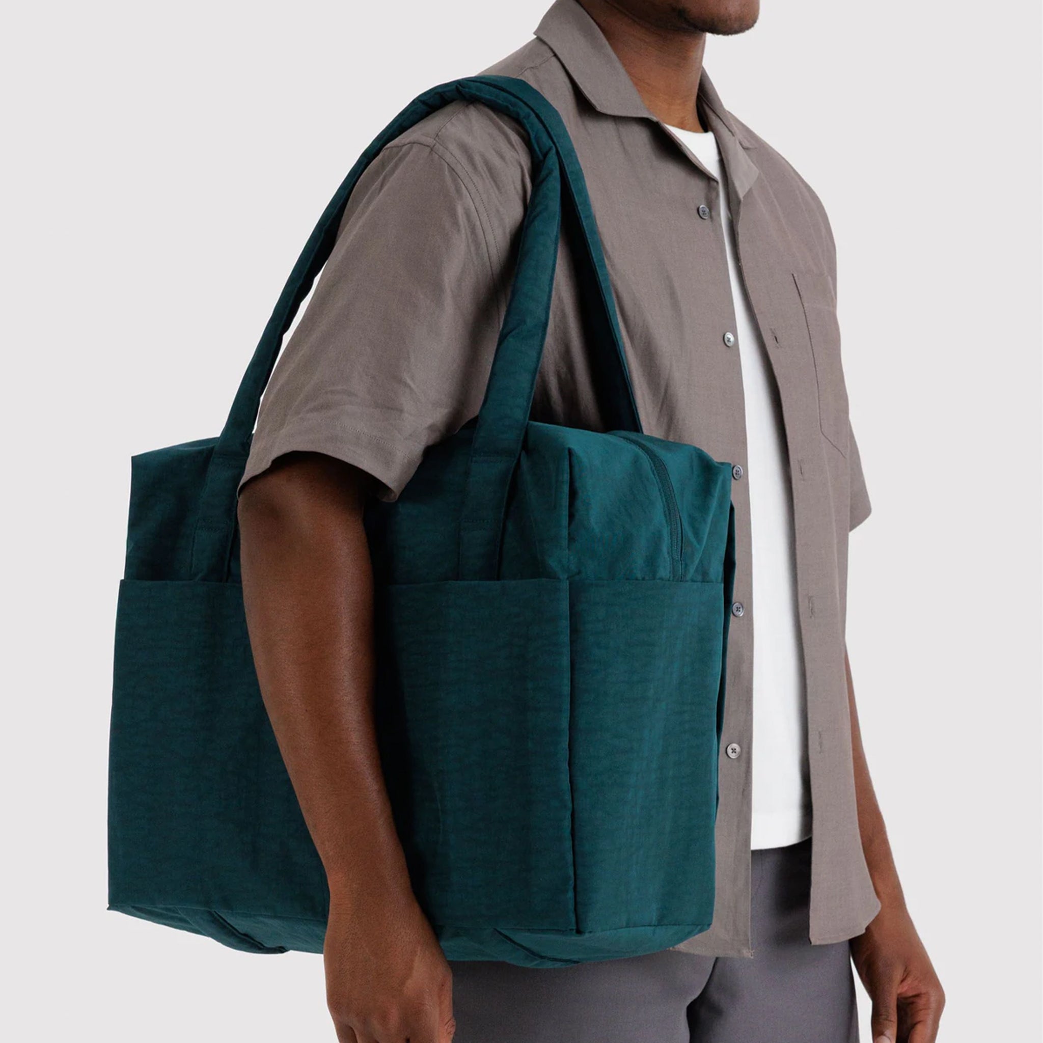 A dark teal colored nylon tote carry on bag. 