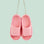 A pink ornament in the shape of a pair of pink cloud slippers. 