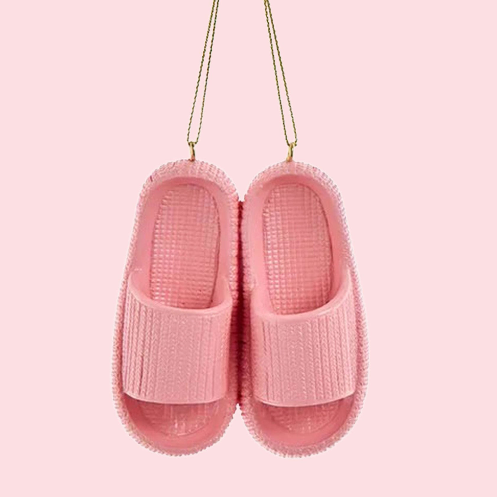 A pink ornament in the shape of a pair of pink cloud slippers. 