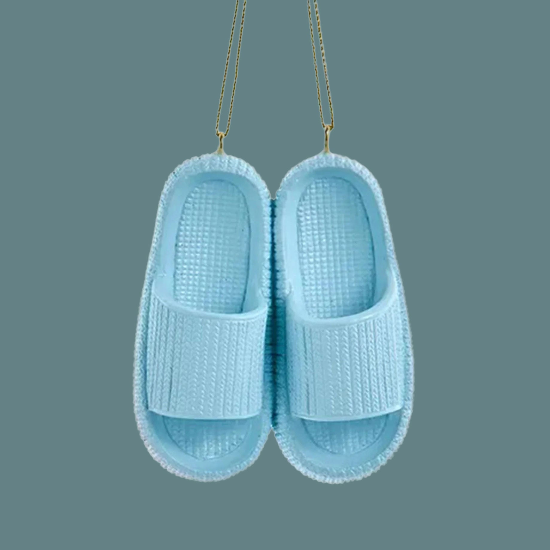 A blue ornament in the shape of a pair of blue cloud slippers. 