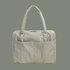 sage colored striped bag on a sage colored background.