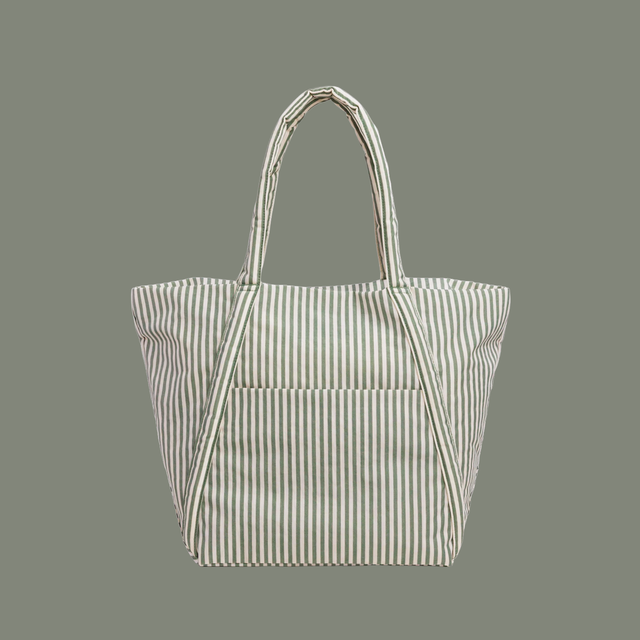 sage colored striped bag with sage colored straps on a sage colored ground.