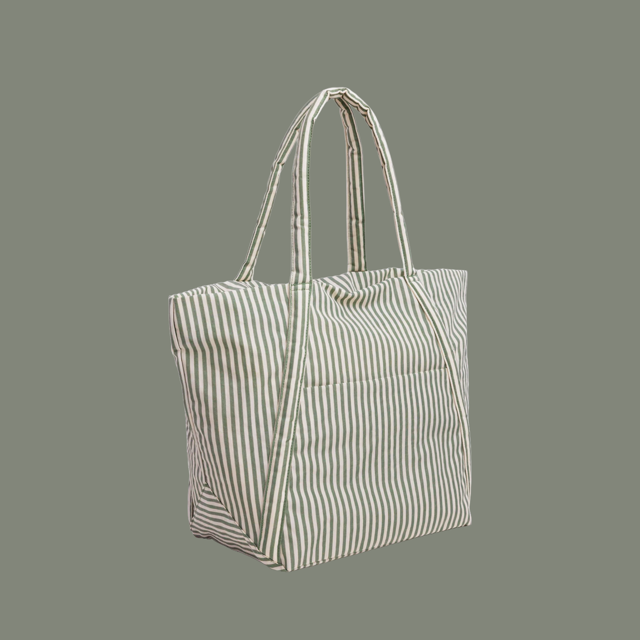 sage colored striped bag with sage colored straps on a sage colored ground.