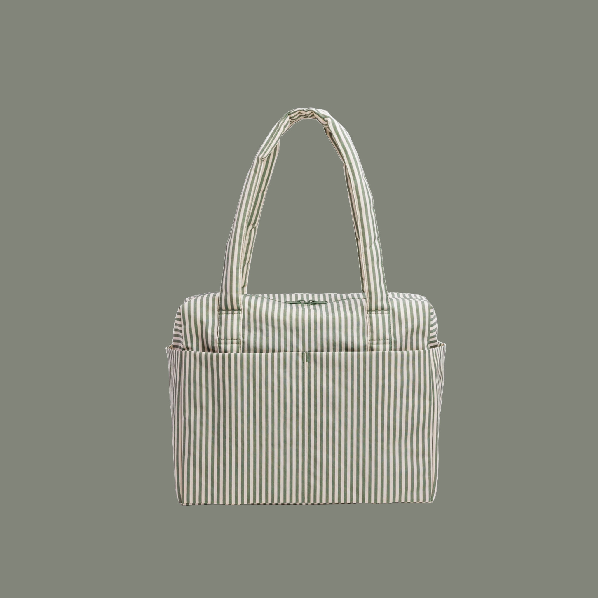 A sage striped nylon carry on bag on a sage background.