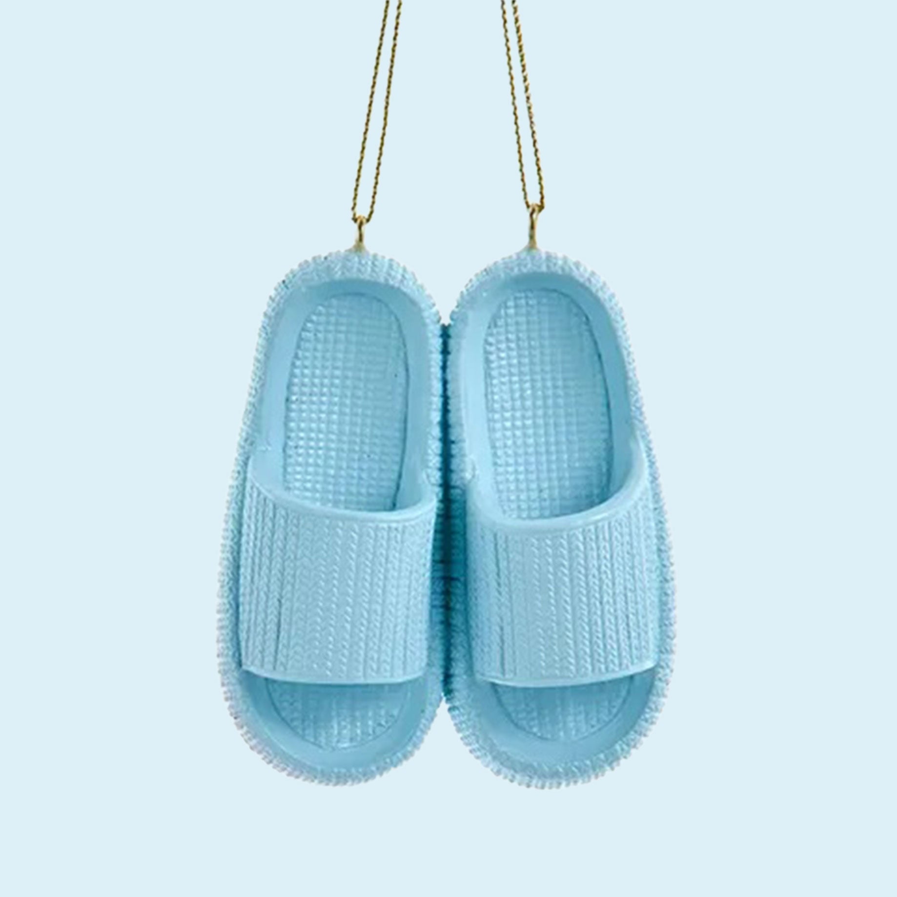 A blue ornament in the shape of a pair of blue cloud slippers. 