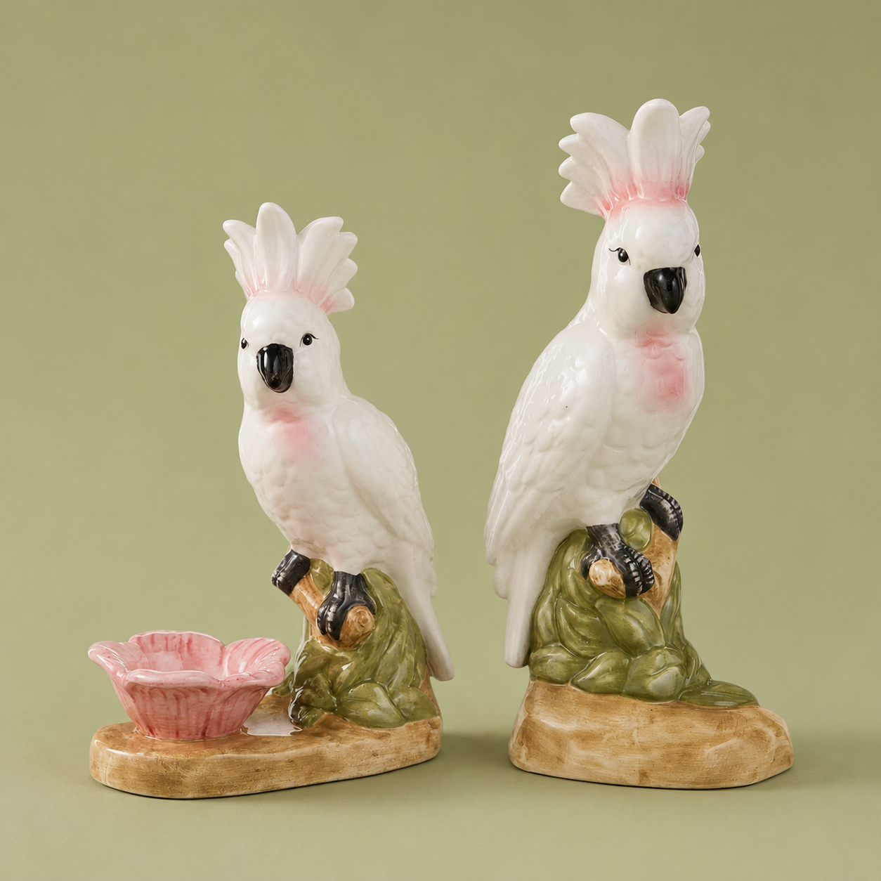 A pair of cockatoo shaped figurines. 