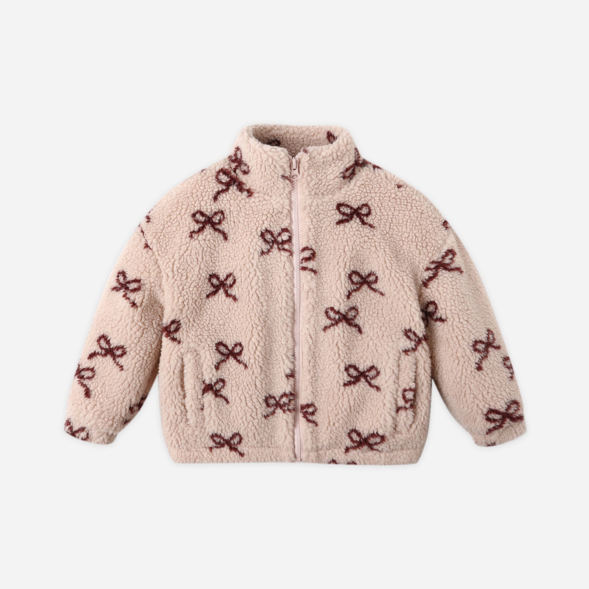 A fuzzy light pink jacket with a dark red bow pattern. 