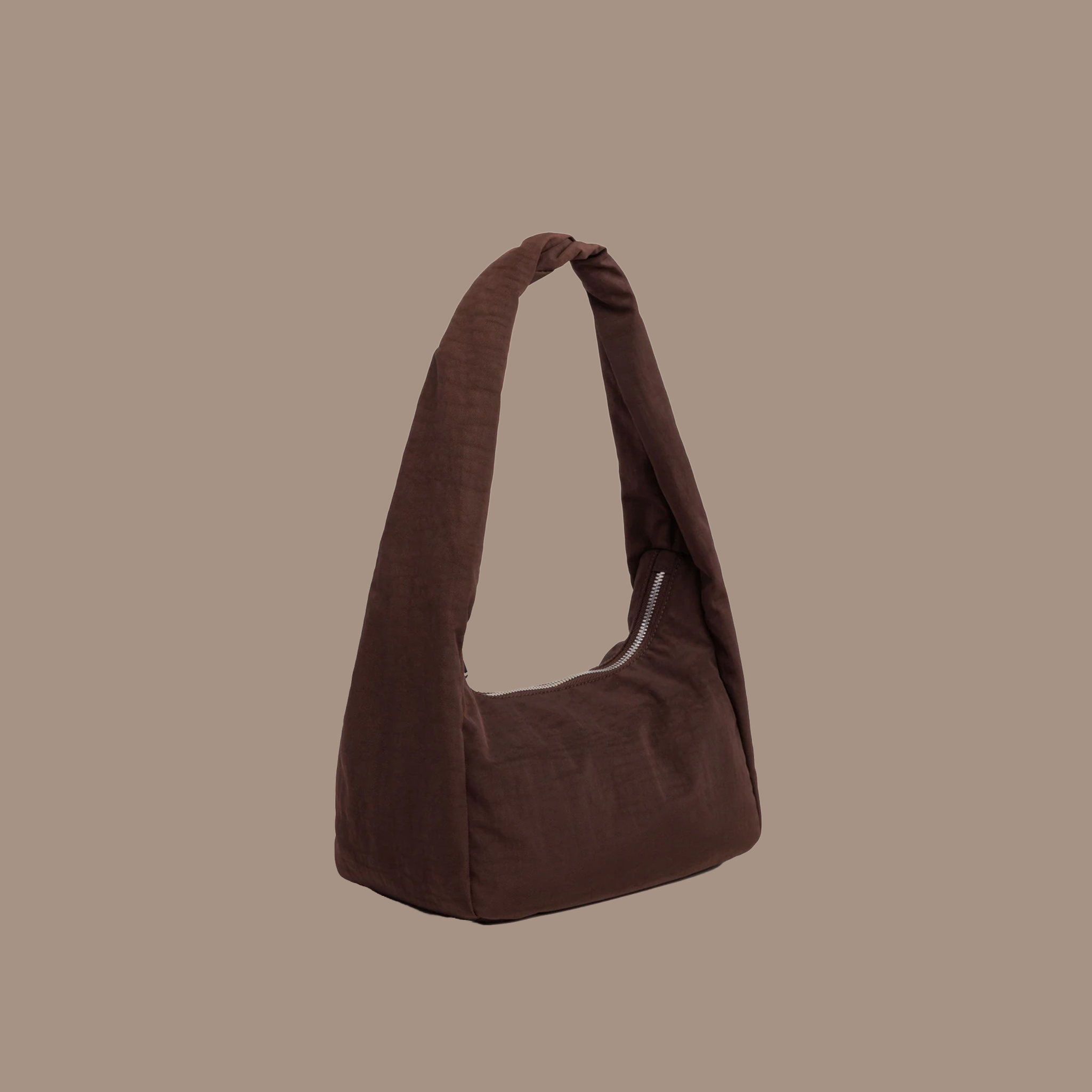 Brown reusable nylon tote with zipper on a brown background. 