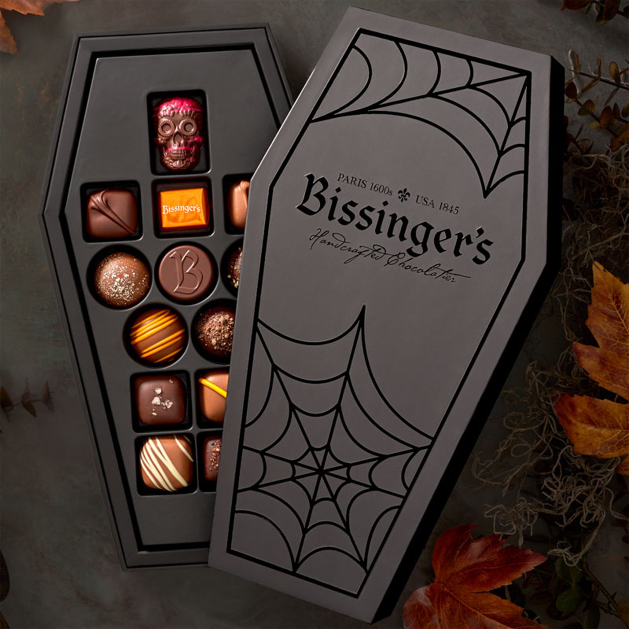 A black coffin shaped box of chocolates. 
