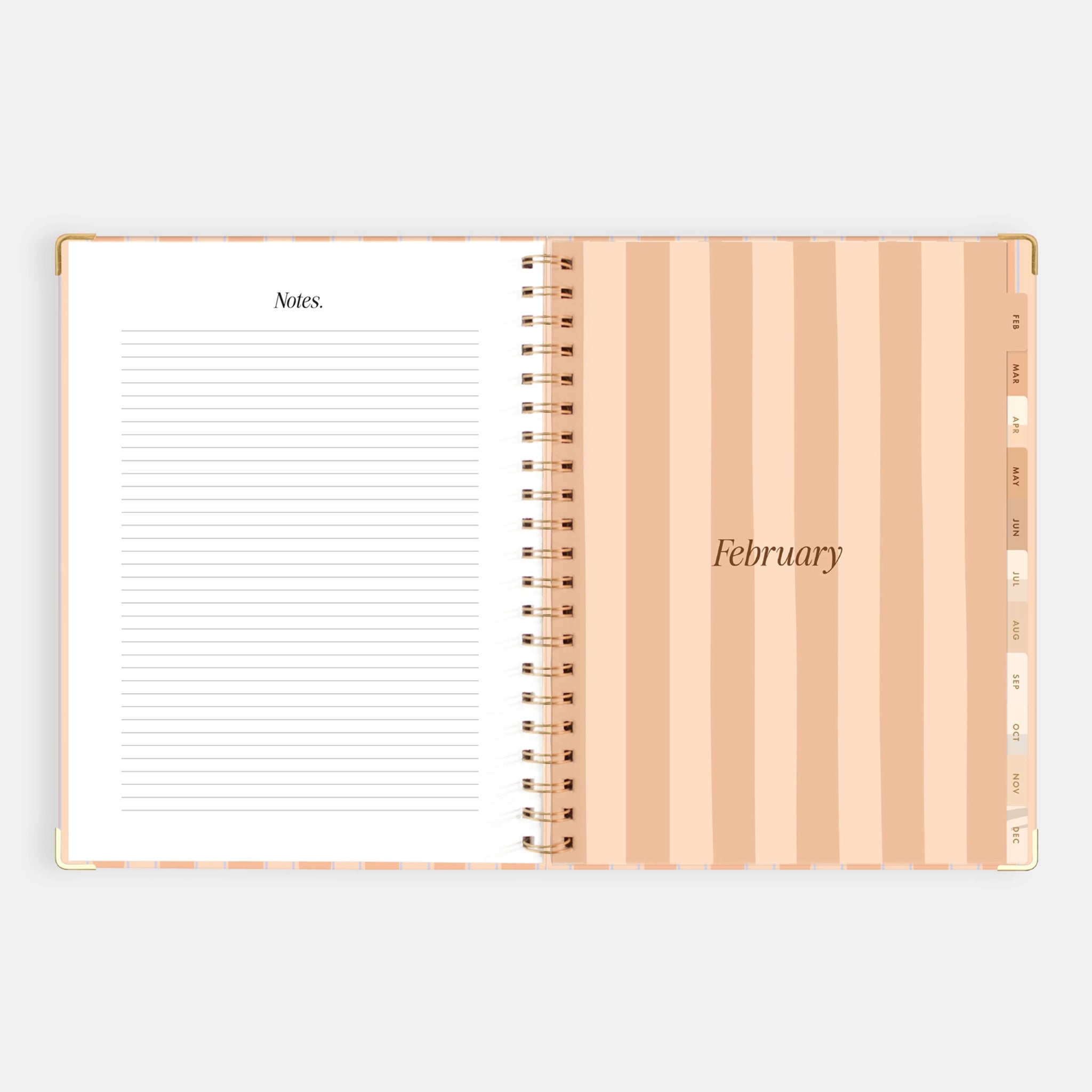 A coral and light blue striped planner with a gold spiral binding and gold foiled text that reads, &quot;2026&quot;. 
