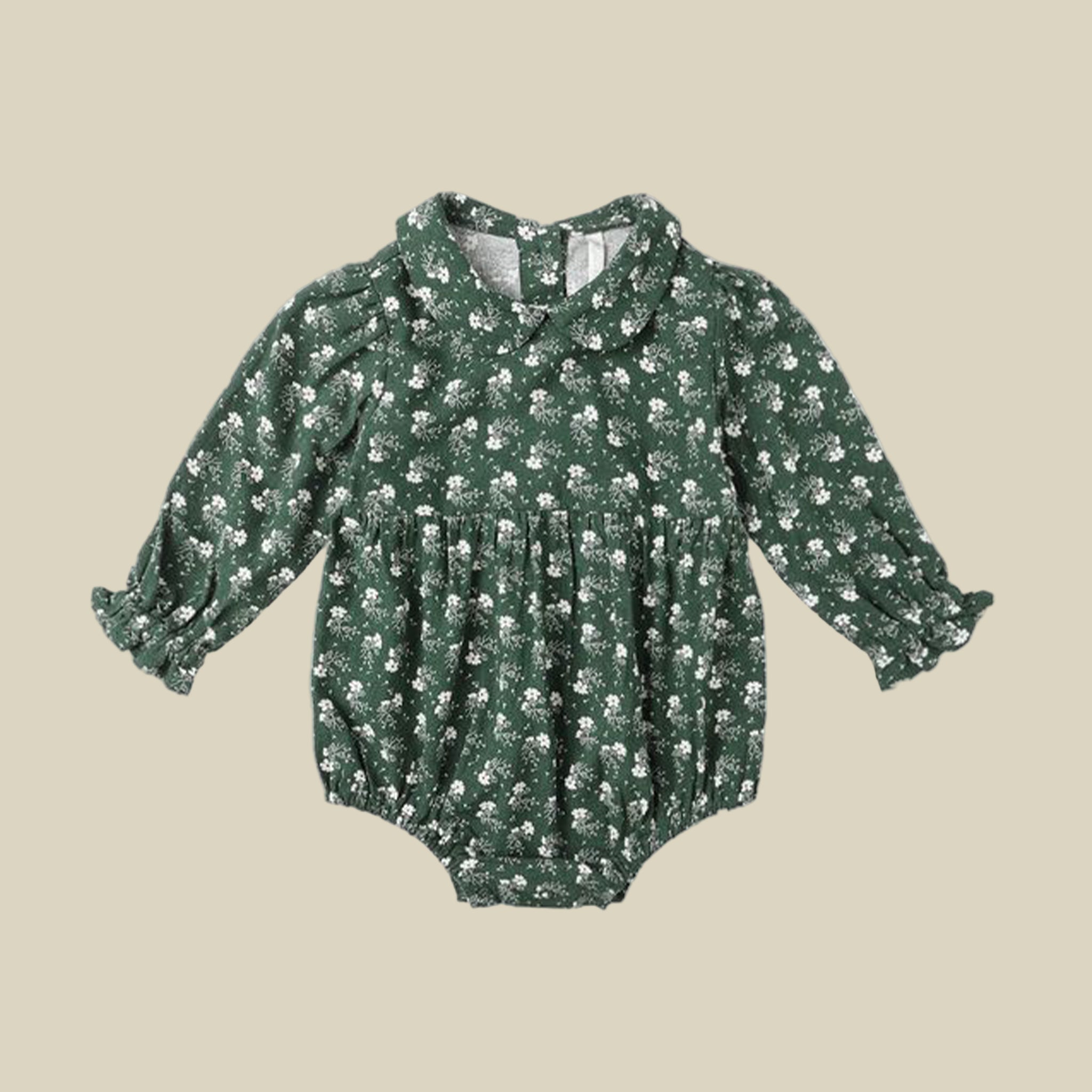 A green long sleeve baby romper with a white floral print and ruffle detailing. 