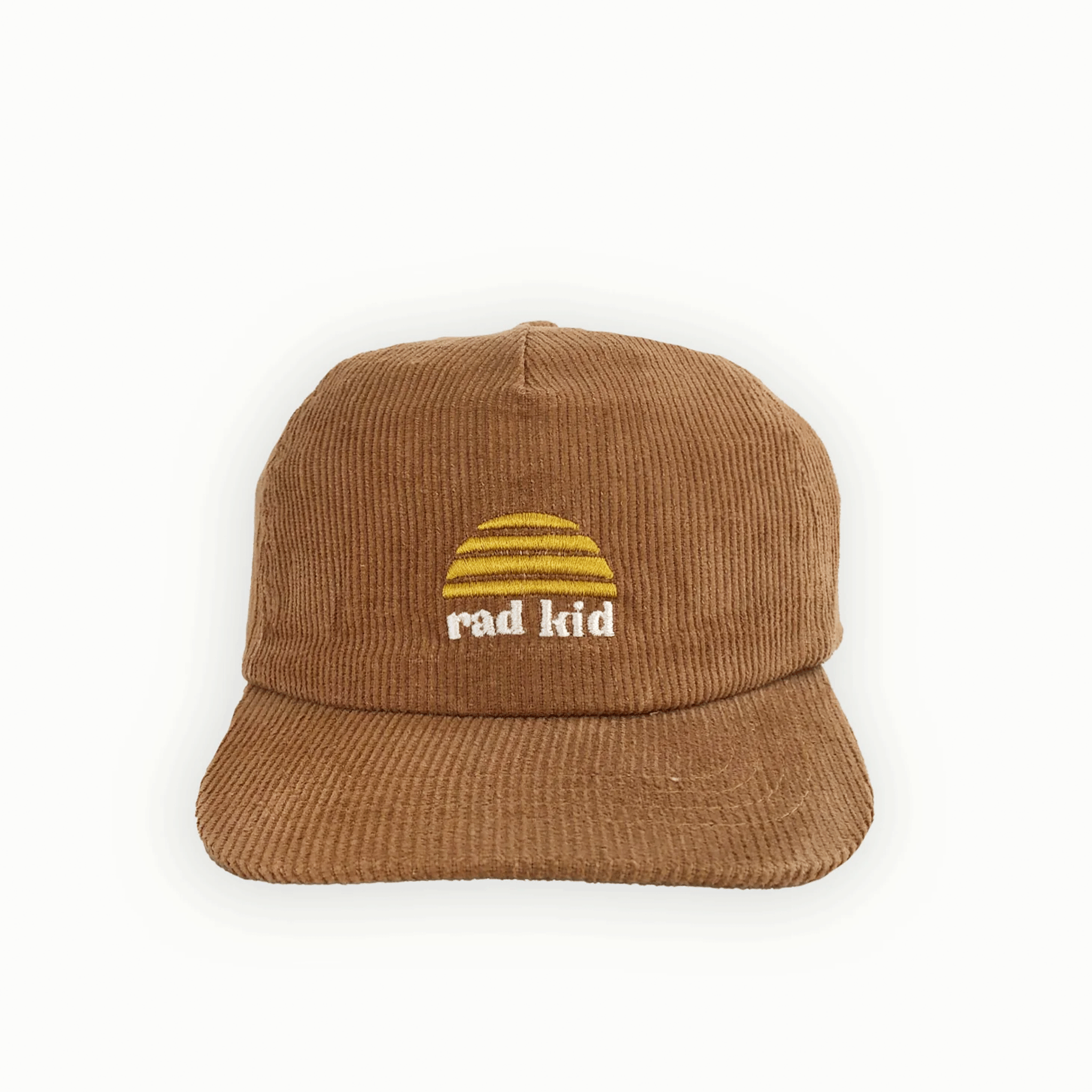 On a white background is a tan corduroy hat with a yellow sun logo and white text below it that reads, &quot;rad kid&quot;.
