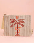 A greyish tan corduroy pouch with a single zipper going across the top and a palm tree, snake and sun graphic in the center.
