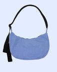 A blue nylon crescent shaped handbag with a black adjustable strap. 