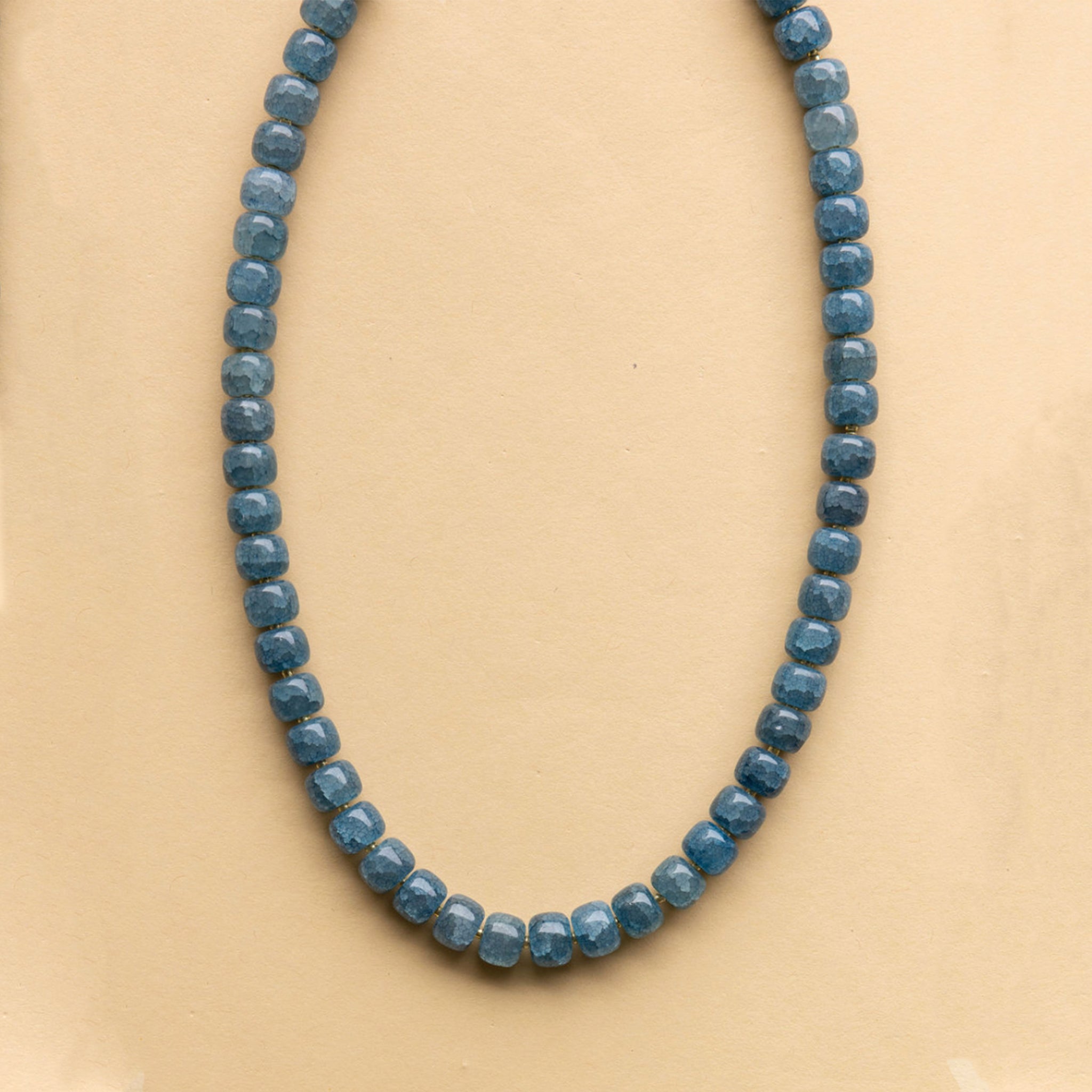 A blue beaded necklace. 