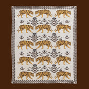 An ivory, brown and yellow tiger patterned blanket. 