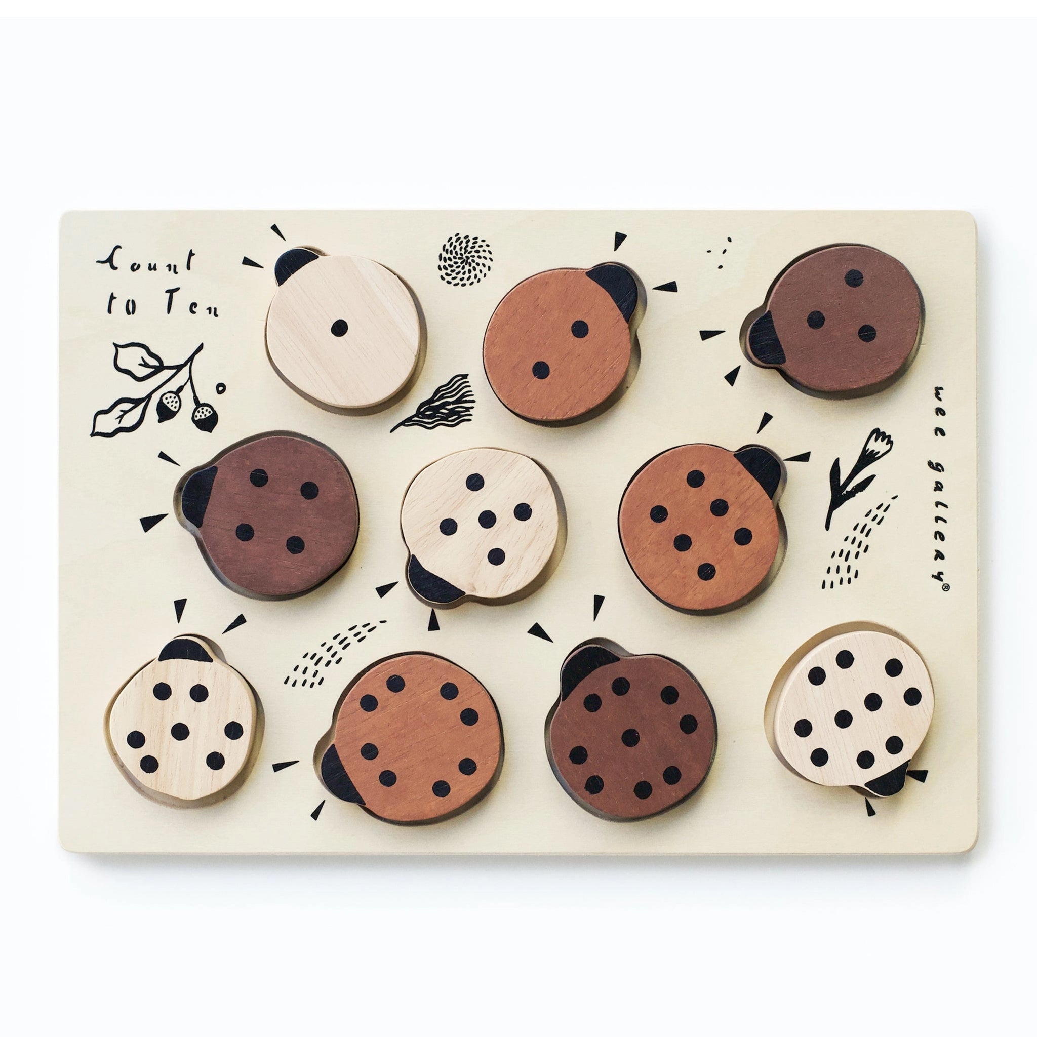 A wooden puzzle with ladybug shapes and numbers underneath. 