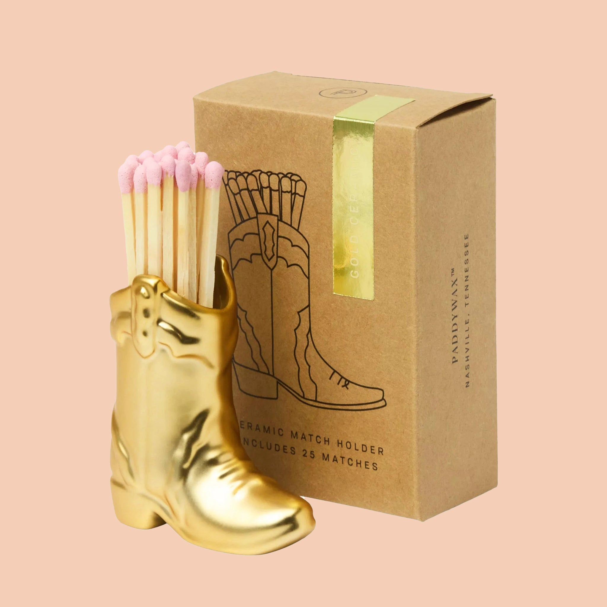 A gold ceramic cowboy boot match holder. 