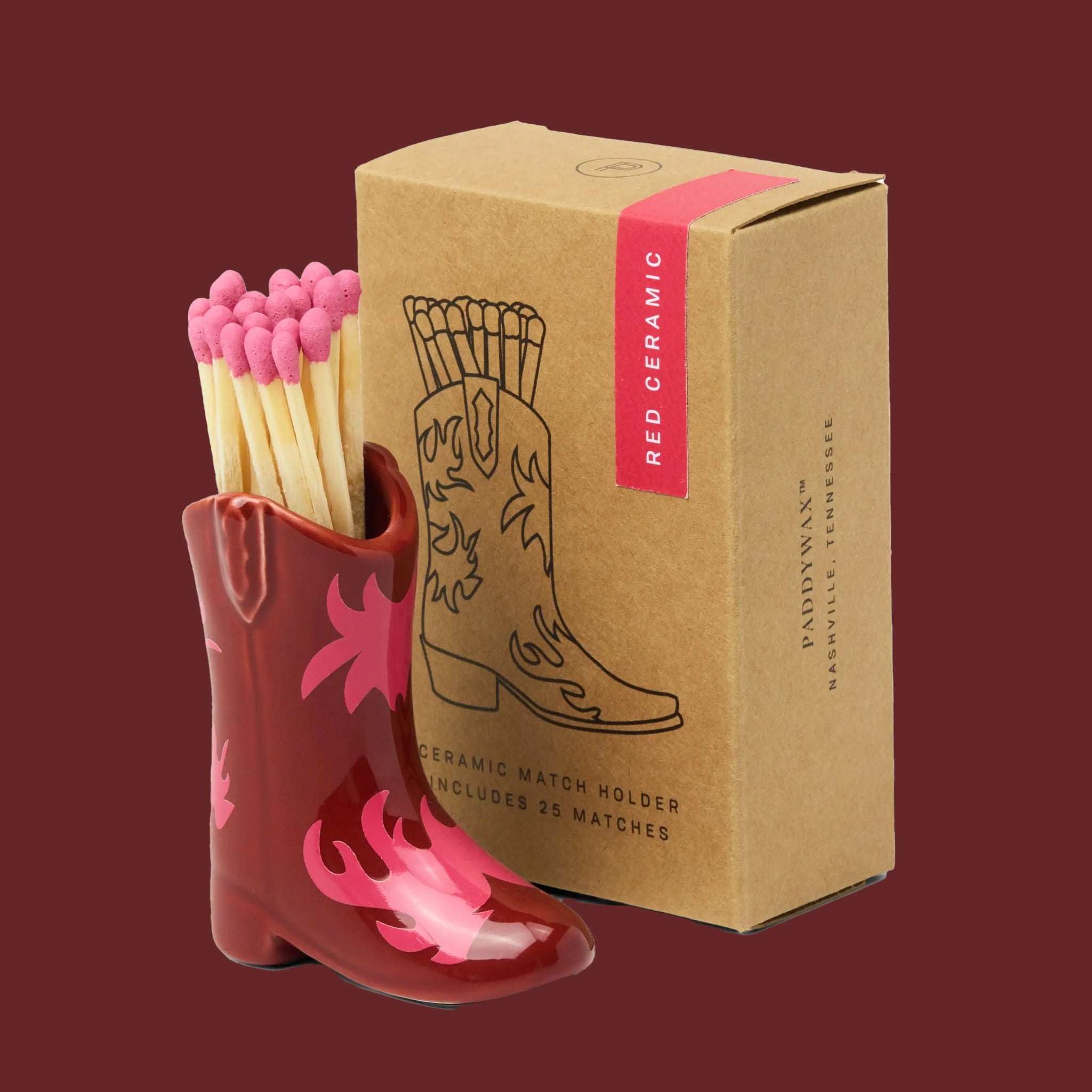 A red ceramic match holder in the shape of a cowboy boot. 