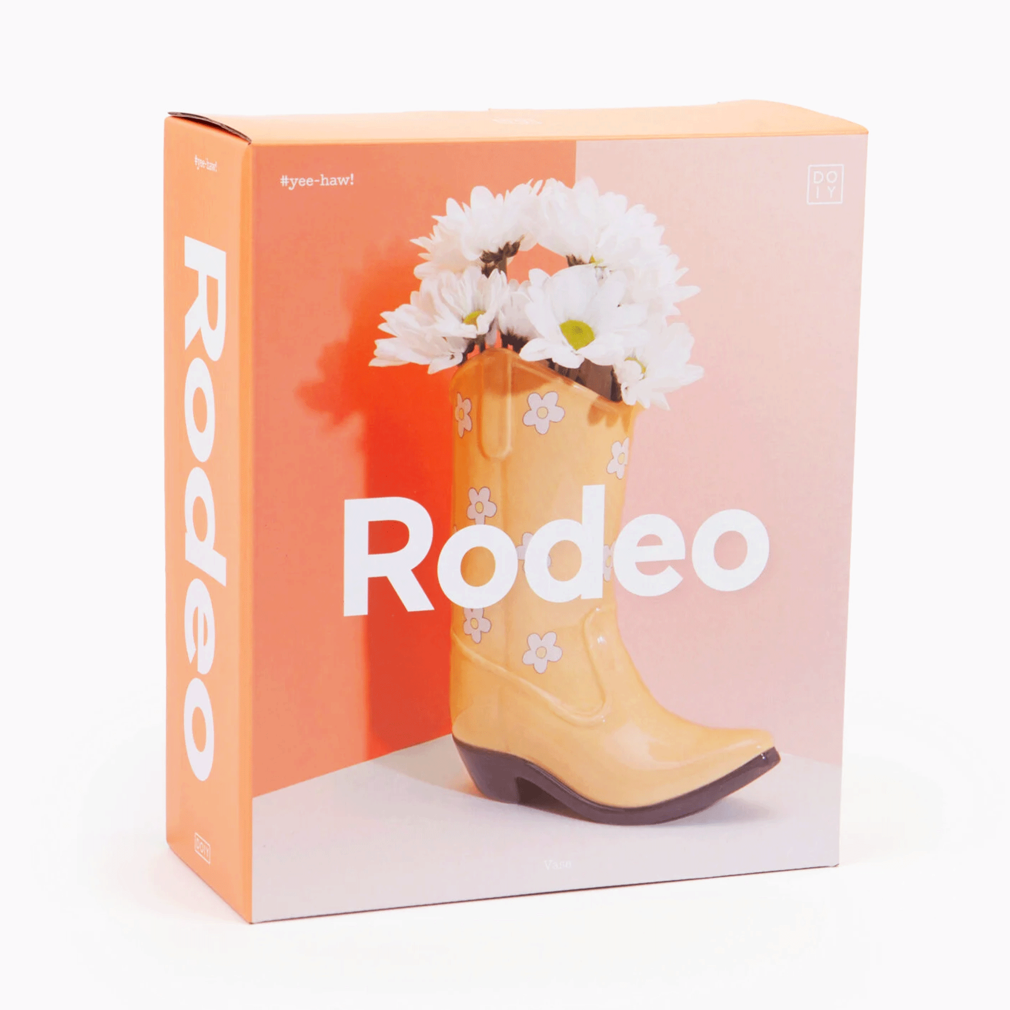 On a white background is a box filled with the yellow cowboy boot shaped vase. Flowers not included with purchase. 