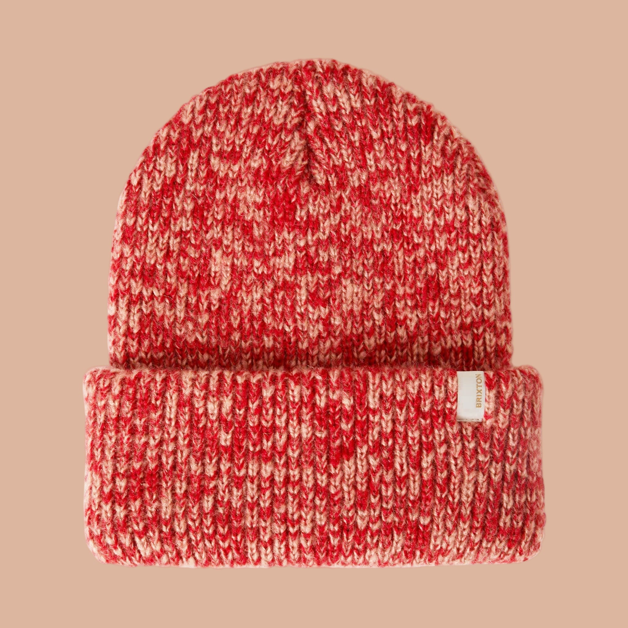 A red and peachy knit beanie. 