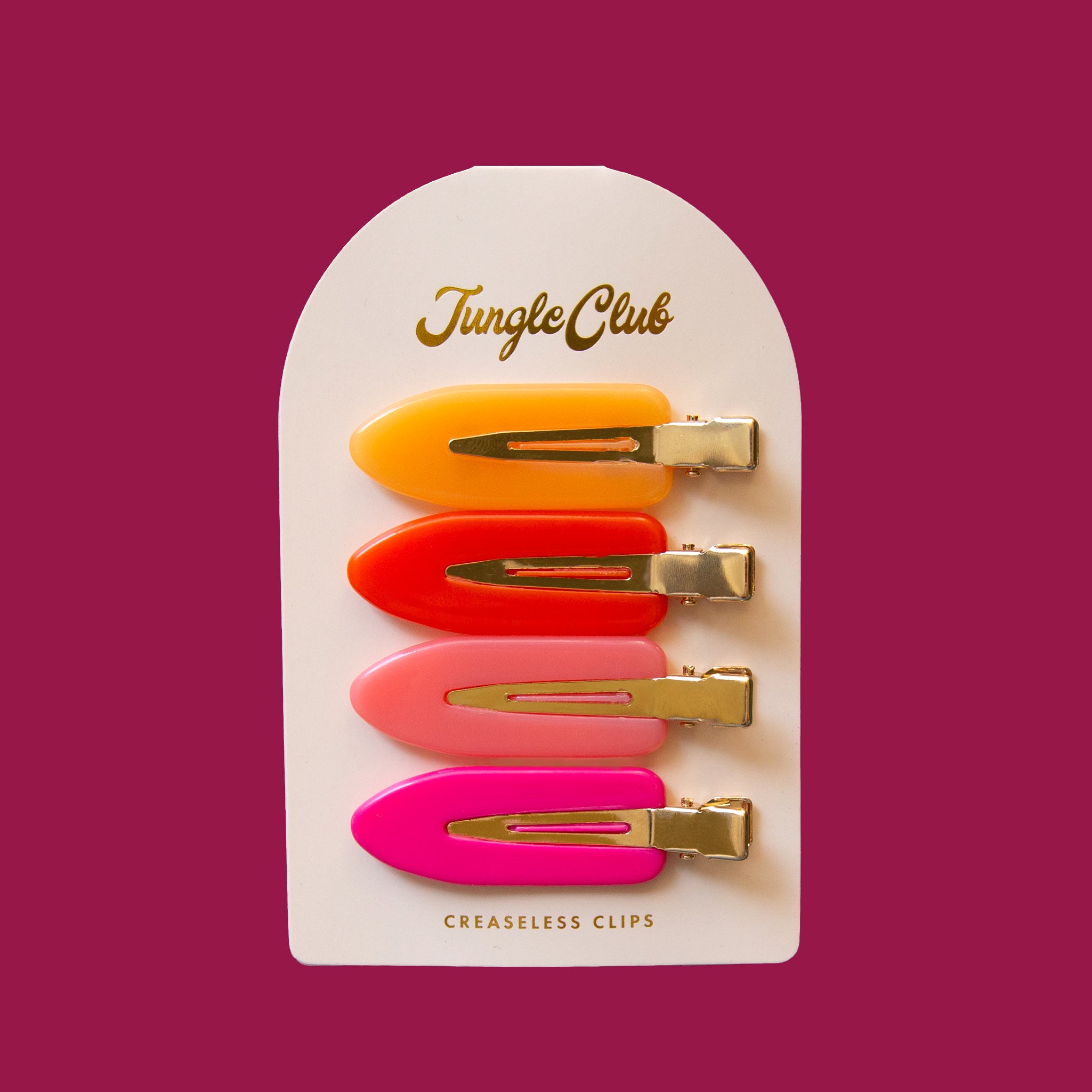 Pack of creaseless hair clips. Each clip is a different color: Hot Pink, Light Pink, Red, and Yellow. The 4 clips are on card stock. 