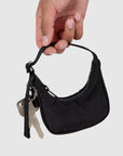 A mini black crescent bag shaped bag charm. 