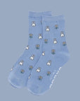 A blue pair of crew socks with a white Miffy and flower pattern. 