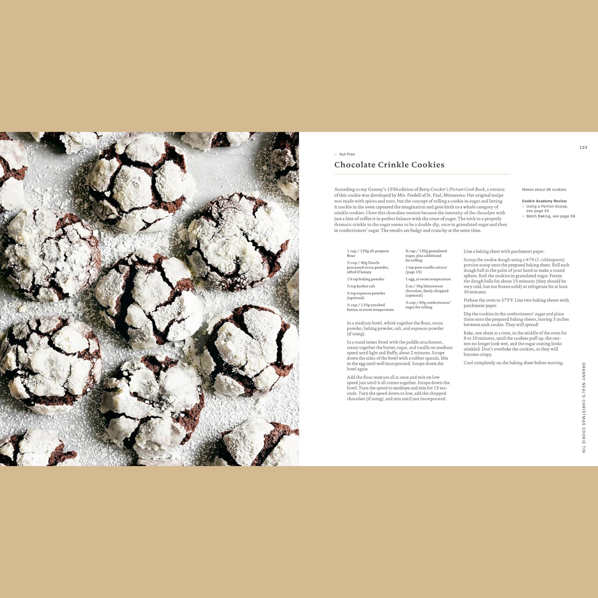 Open cookbook spread featuring a recipe for chocolate crinkle cookies, with a photo on the left of dark chocolate cookies coated in powdered sugar with cracked tops, and recipe text on the right.