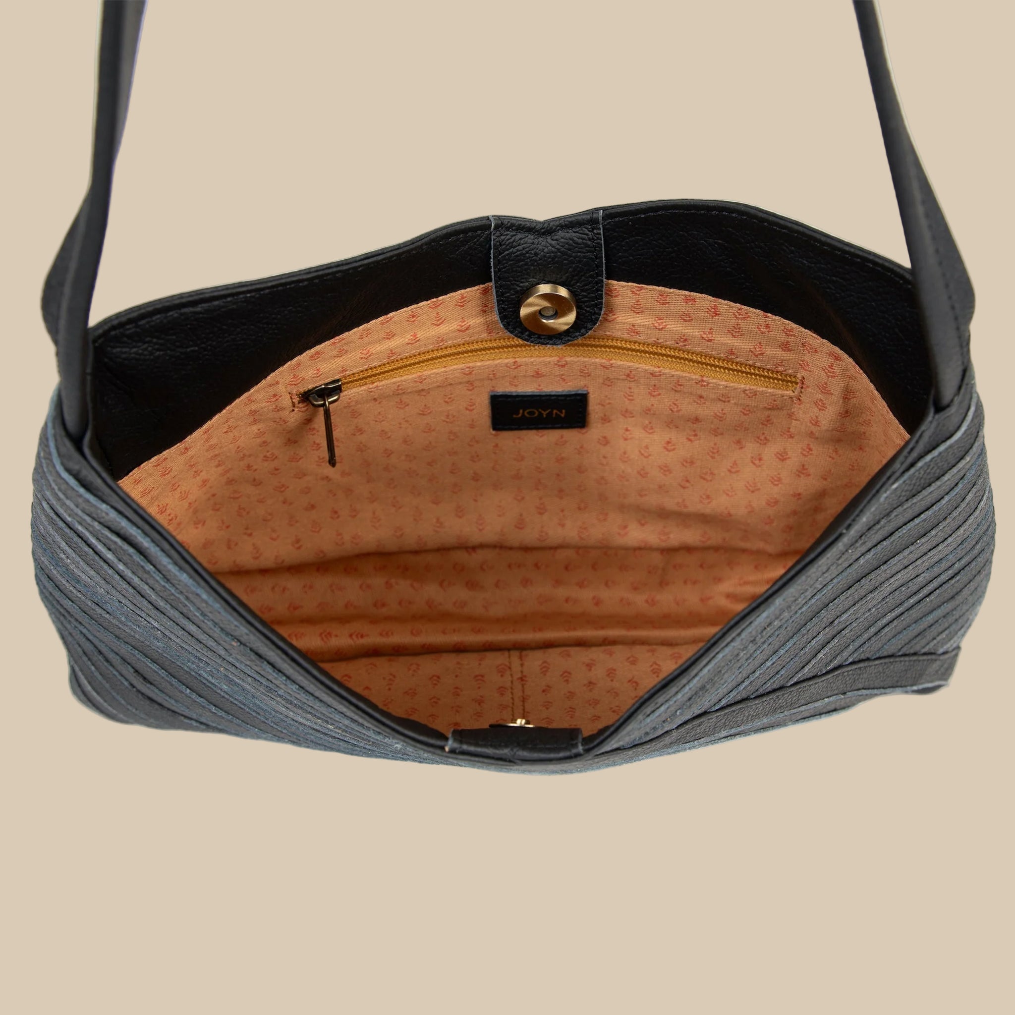 A black crisscross designed shoulder handbag. 