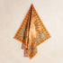 An orange and green crocodile print bandana.