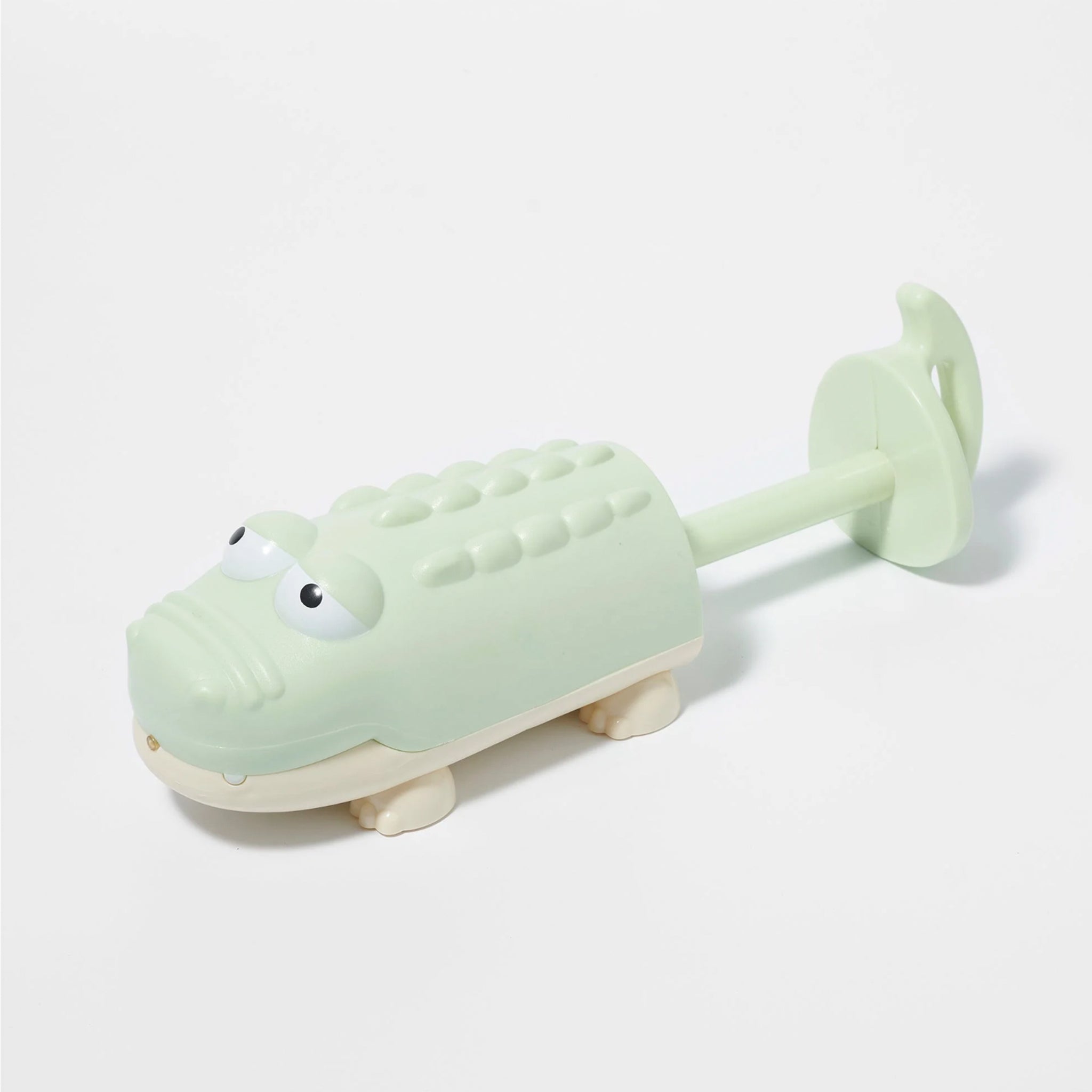 A crocodile shaped beach, pool or bath toy in a green and cream shade.