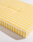 A white and yellow cushion lounge chair cushion sold separately from the chair base.